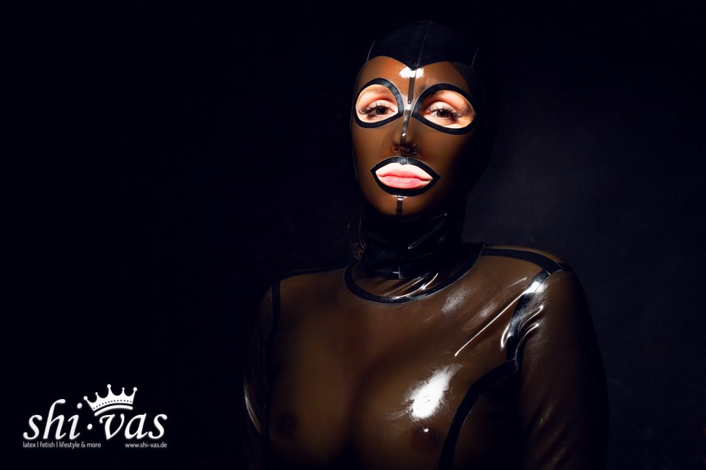 Finnja blickt leicht geneigt in die Kamera, das Licht spiegelt sich intensiv auf der Stirnpartie der Maske.